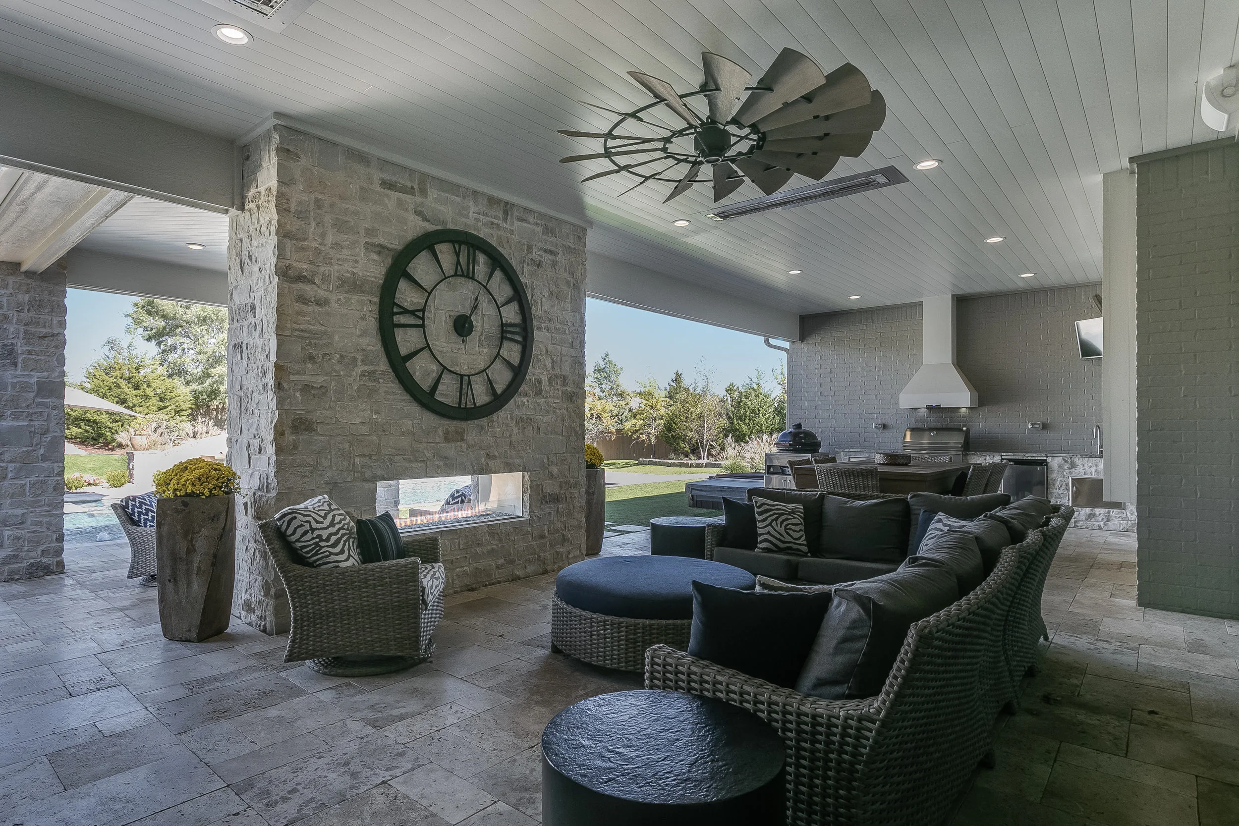 Covered outdoor living area with stone fireplace
