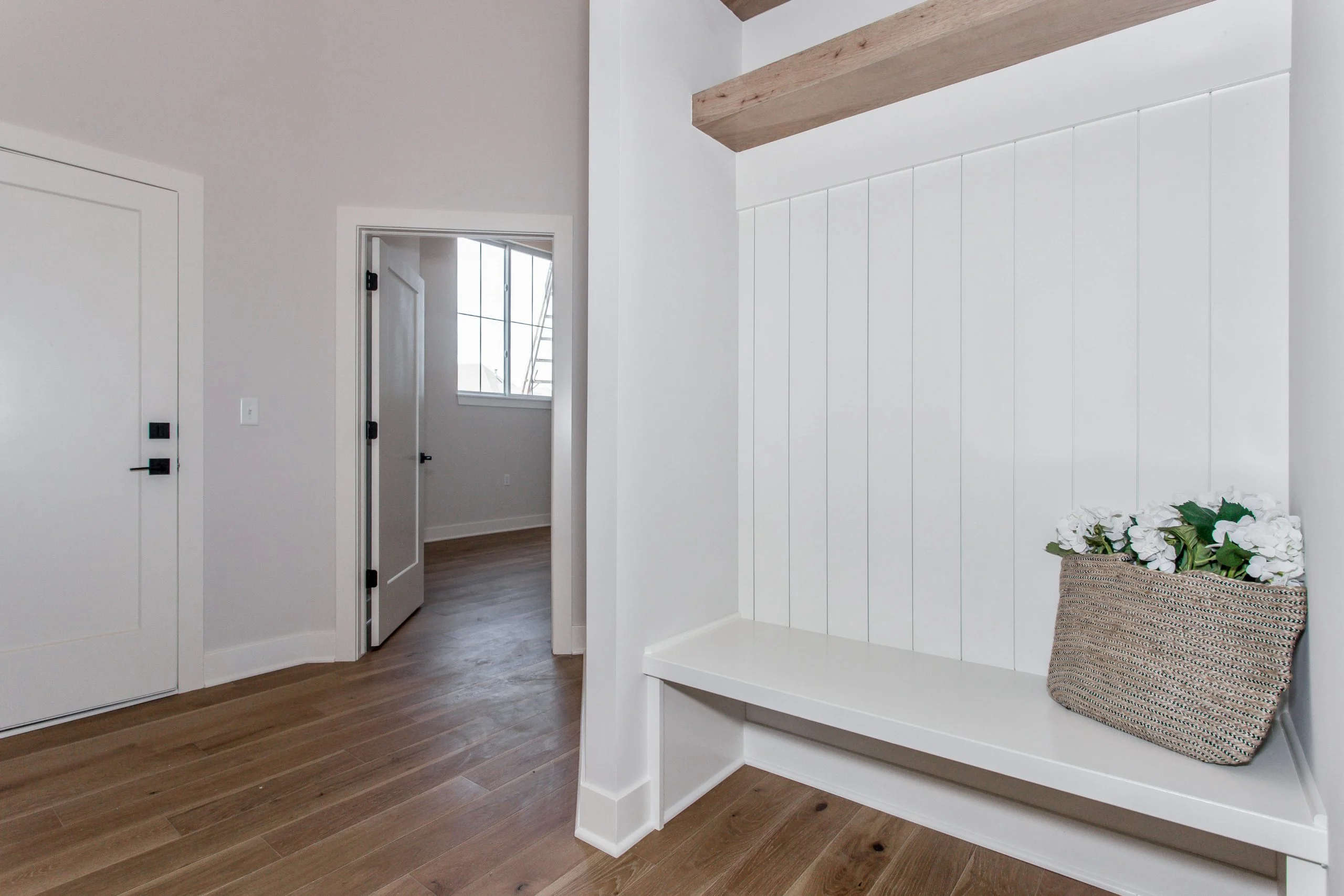 Mudroom hall with a built-in bench and wide doorways