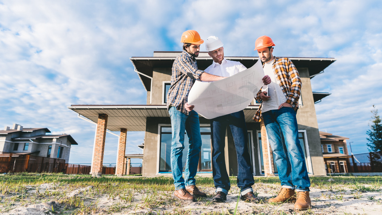 Builders Looking At Blueprints In Wichita Ks