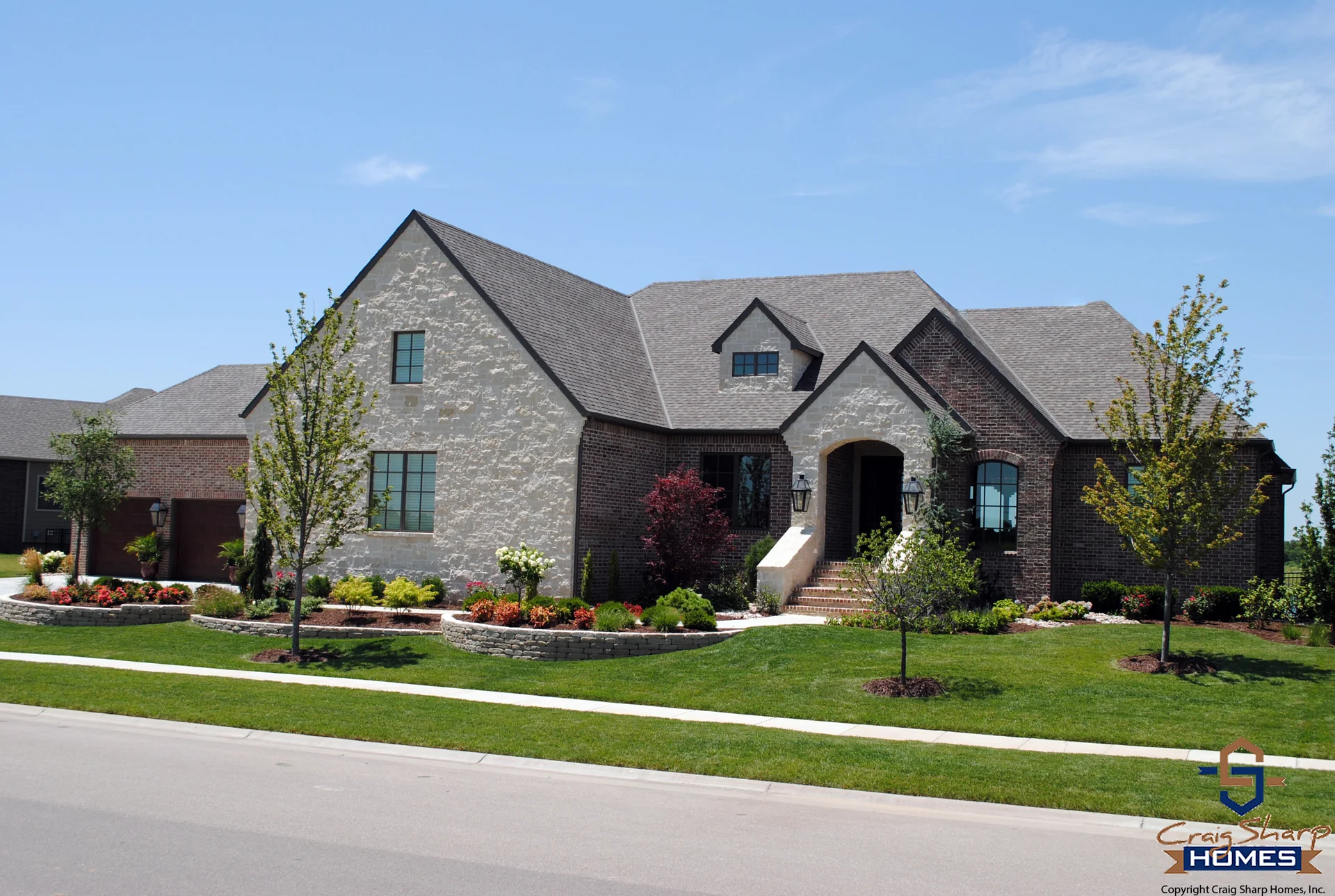 Brick and stone custom home built by Sharp Homes in Wichita, the kind veterans can build with a VA loan