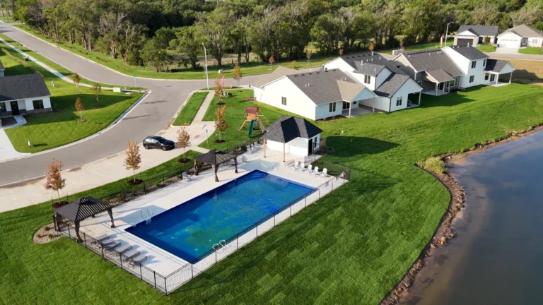 Aerial view of the Long Beach community pool, pool house and playground beside the lake in Maize, Kansas